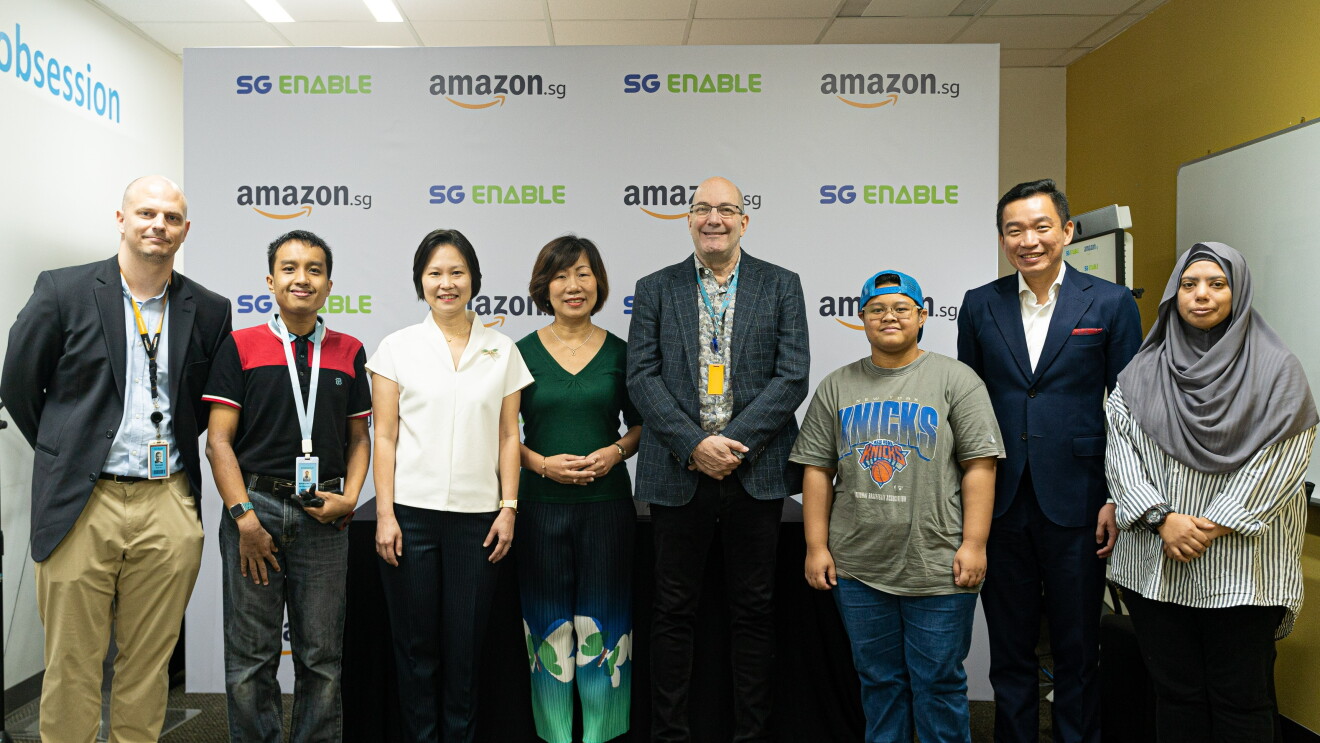 Group photo with Associates with Disabilities and Amazon Singapore, against a backdrop with Amazon.sg logo and SG Enable 