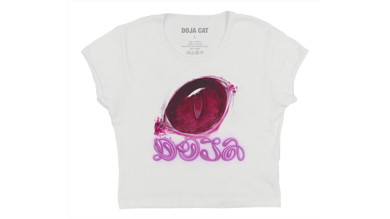 A cropped white t-shirt with a red eye on it. Below the eye is pink writing that says "Doja."