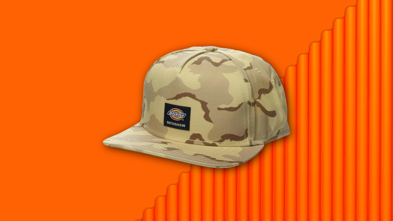 A Dickies skateboarding cap floating against a vibrant orange background.