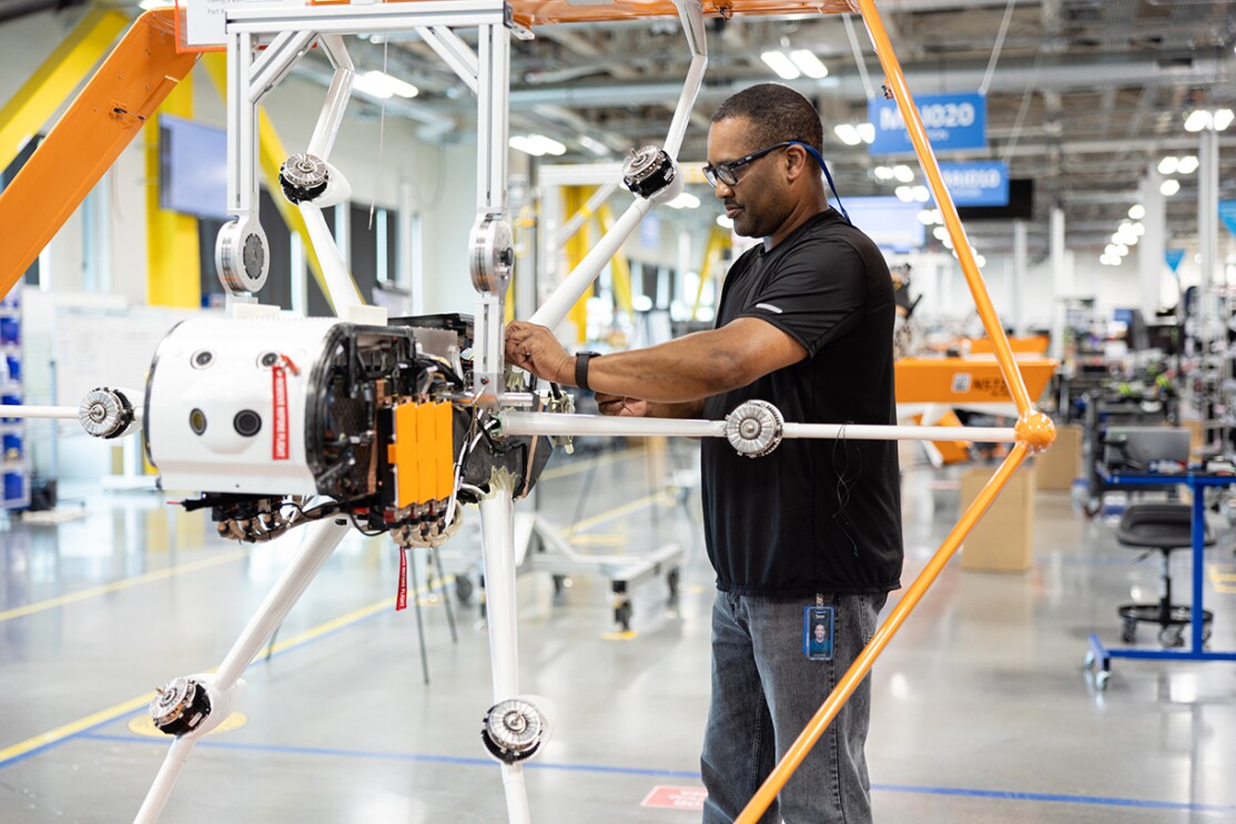 A Prime Air employee working at a drone manufacturing assembly line.