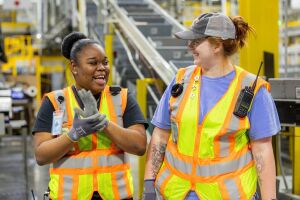 Amazon employees wear safety vests in a fulfillment center