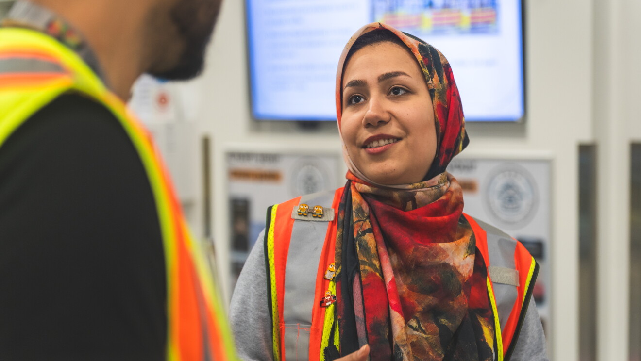 Image of an Amazon employee talking to a colleague