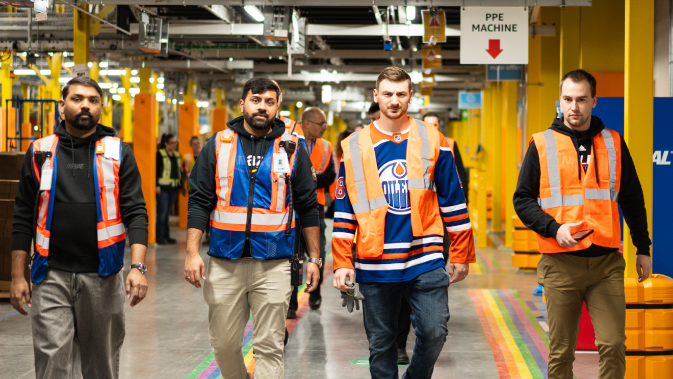 hockey player helping package boxes 