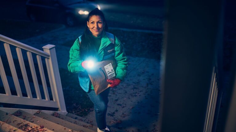 Amazon delivery driver delivers a package to a customer.