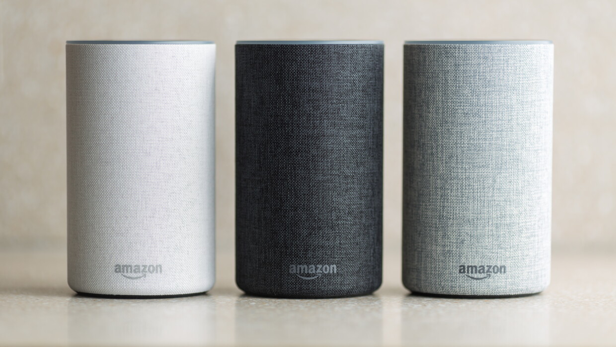 A trio of Amazon Echo devices in white, black, and grey.