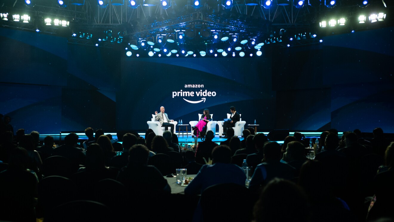 Jeff Bezos sits on stage with Bollywood star Shah Rukh Khan and director Zoya Akhtar during Prime Video in India update and announcement.