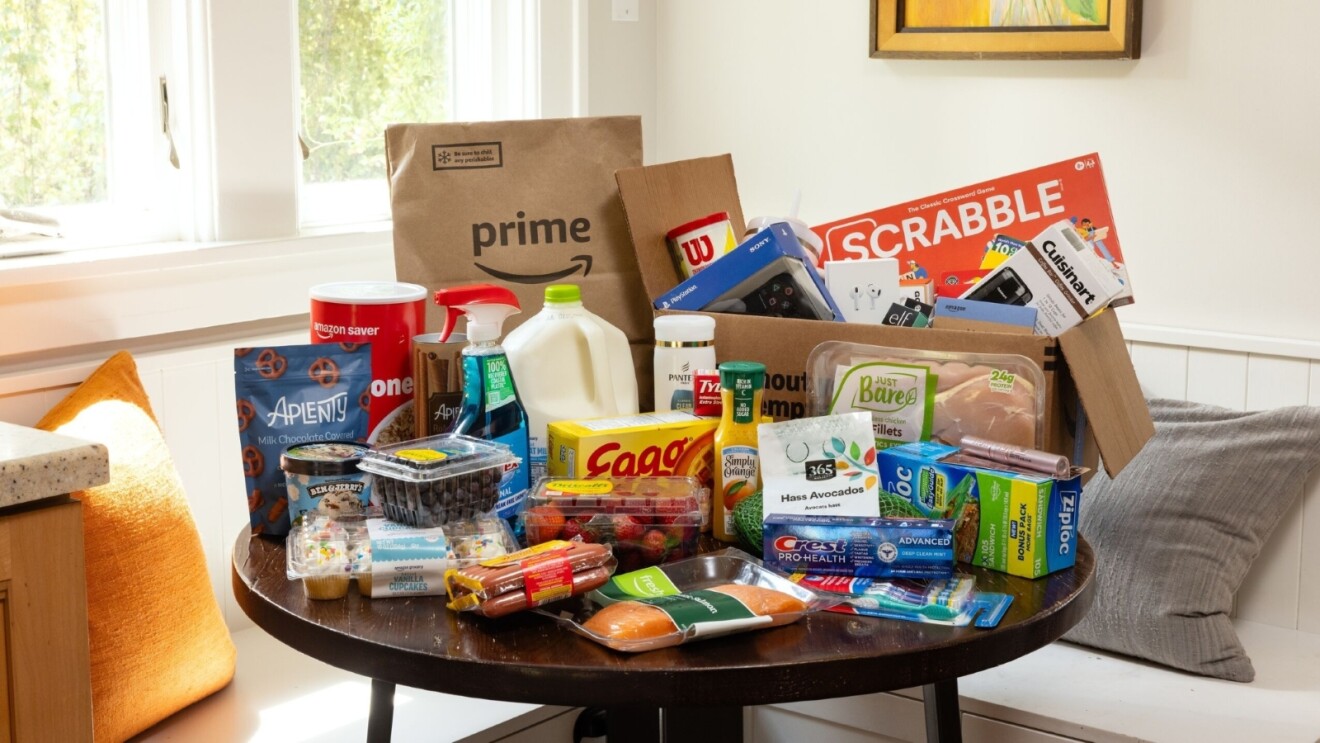 Amazon Prime delivery with groceries, household items, and board games on table