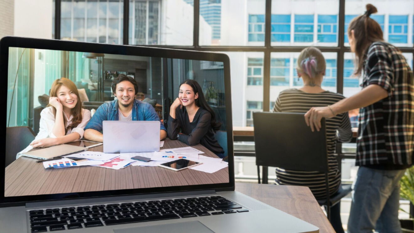 An image of a laptop screen showing three people on a video call.