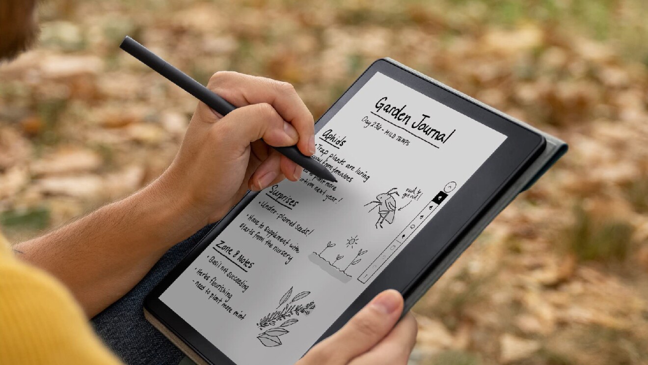 Prime Day 2023 live blog best deals: image of someone using their Kindle Scribe to make a garden journal in a park.