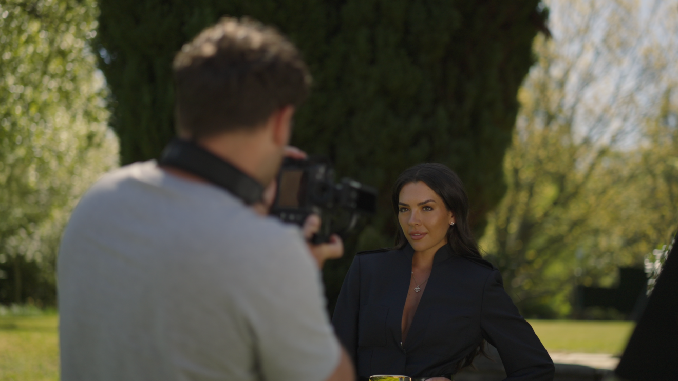 Gemma Owen having her photo taken in a garden background