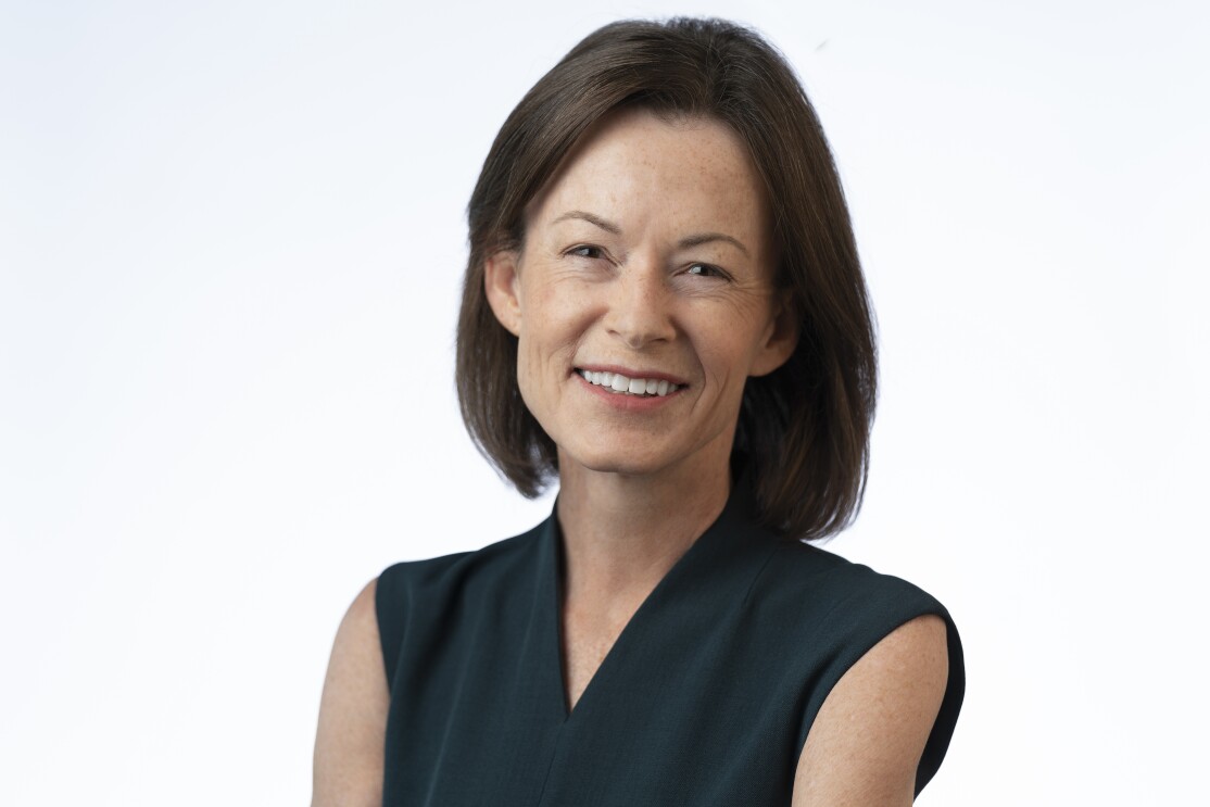 Ardine Williams wears a black blouse and smiles.