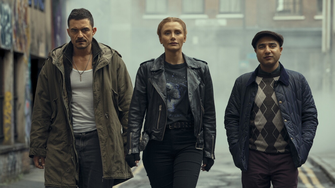 Gritty urban scene with three determined-looking individuals
