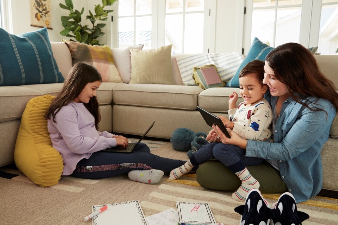 Parent with two young children, accessing parent-approved games and apps