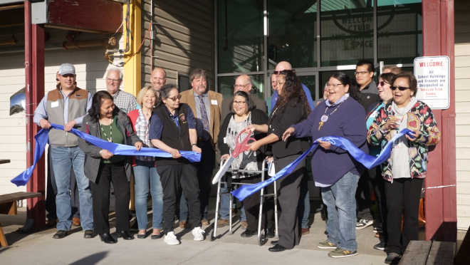 An image of a group of people cutting the ribbon to open the new learning center.