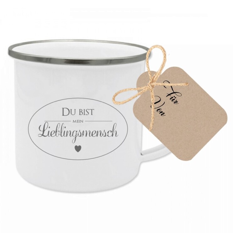 Eine weiße Tasse mit schwarzem Rand mit der Aufschrift "Du bist mein Lieblingsmensch" ist auf dem Bild zu sehen.