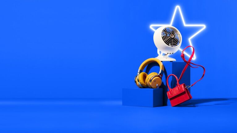 Glowing star icon with electronic gadgets and accessories on blue background