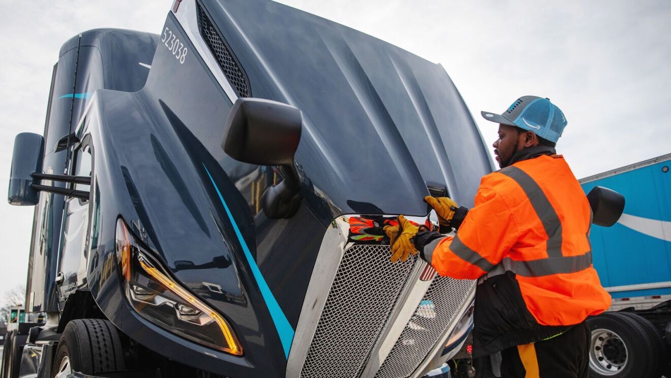 portraits and environmental photos of abel tuyisenge, a transportation operations management associate at amazon, as he drives and inspects trucks