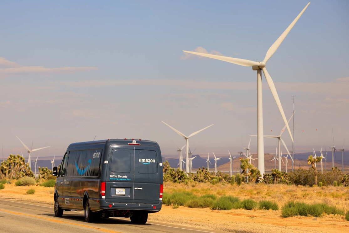 Amazon vehicle passing a wind farm