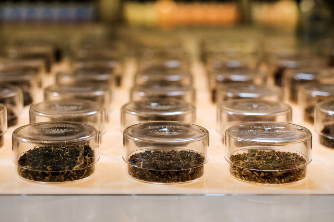 Clear, lidded containers hold loose-leaf tea.