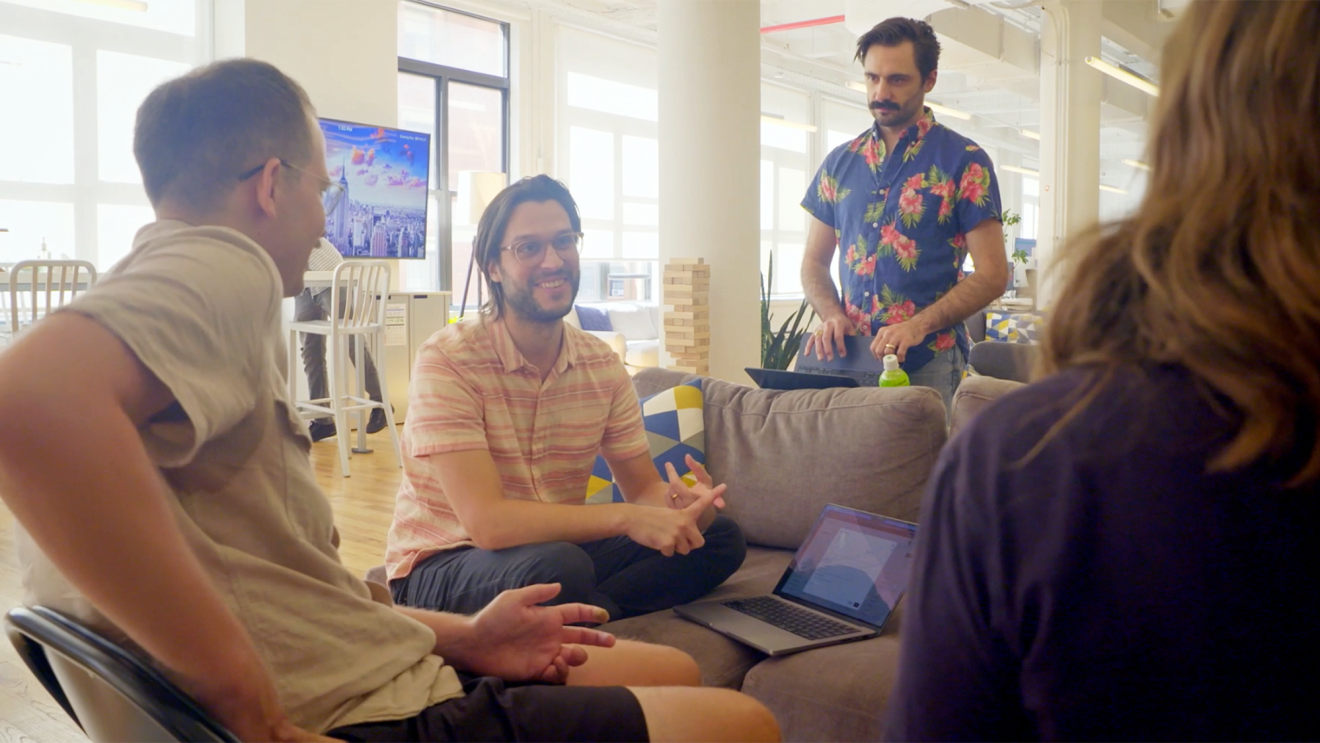 A photo of startup employees meeting in an office space.