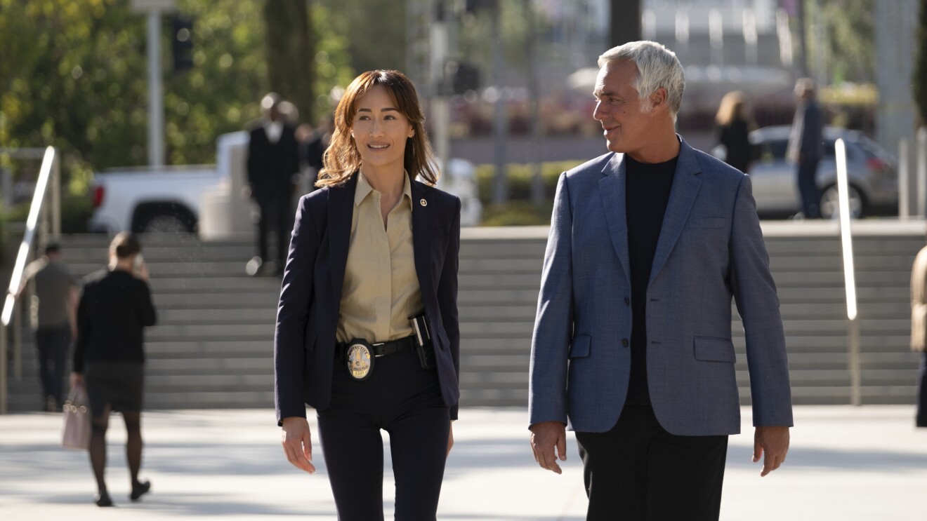 Two police officers walk in front of some steps in Los Angeles