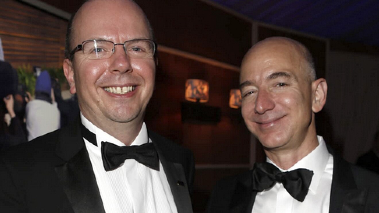 A photo of Col Needham, founder and CEO of IMDb next to Jeff Bezos.