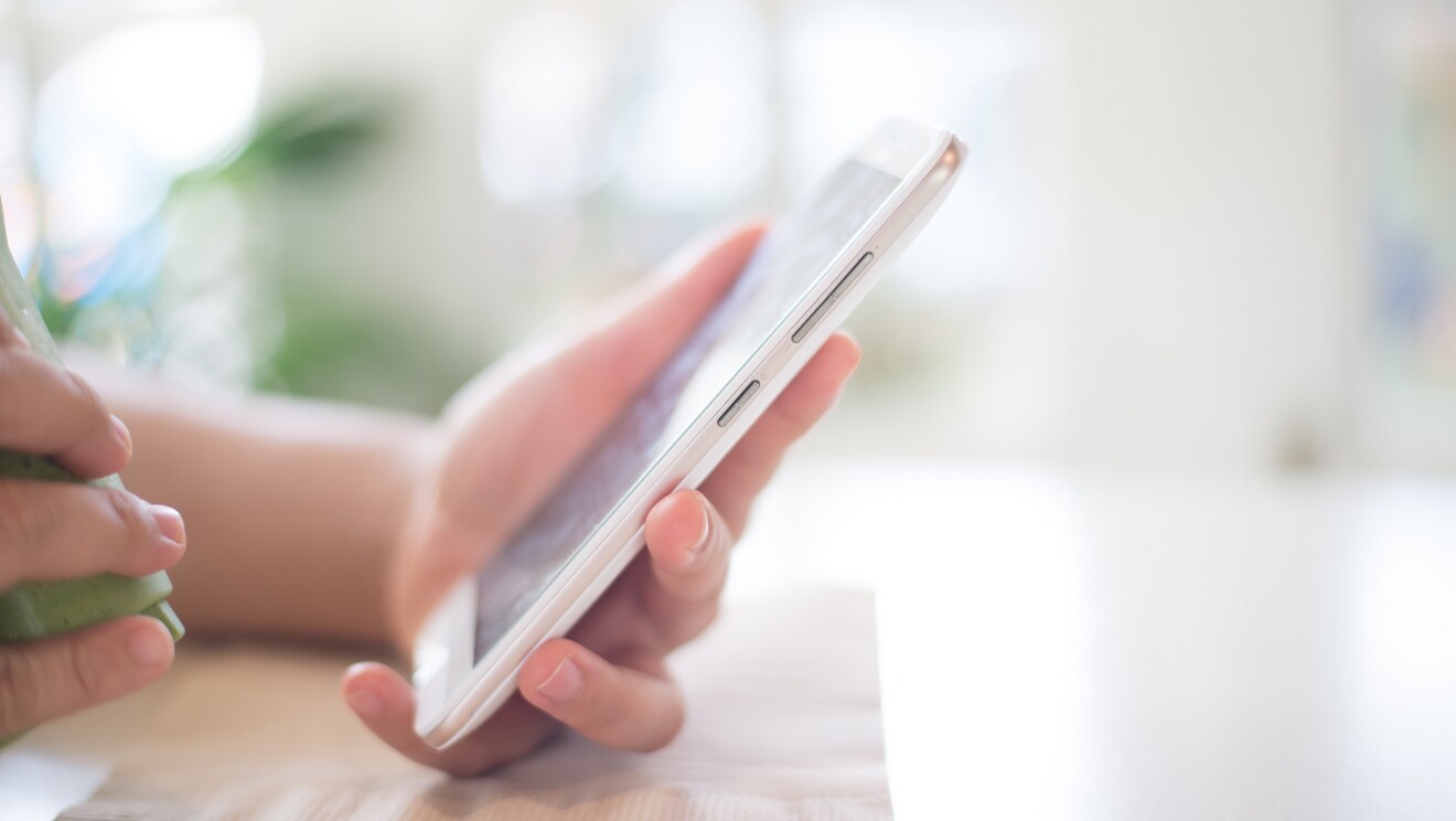 An image of a hand with a mobile phone