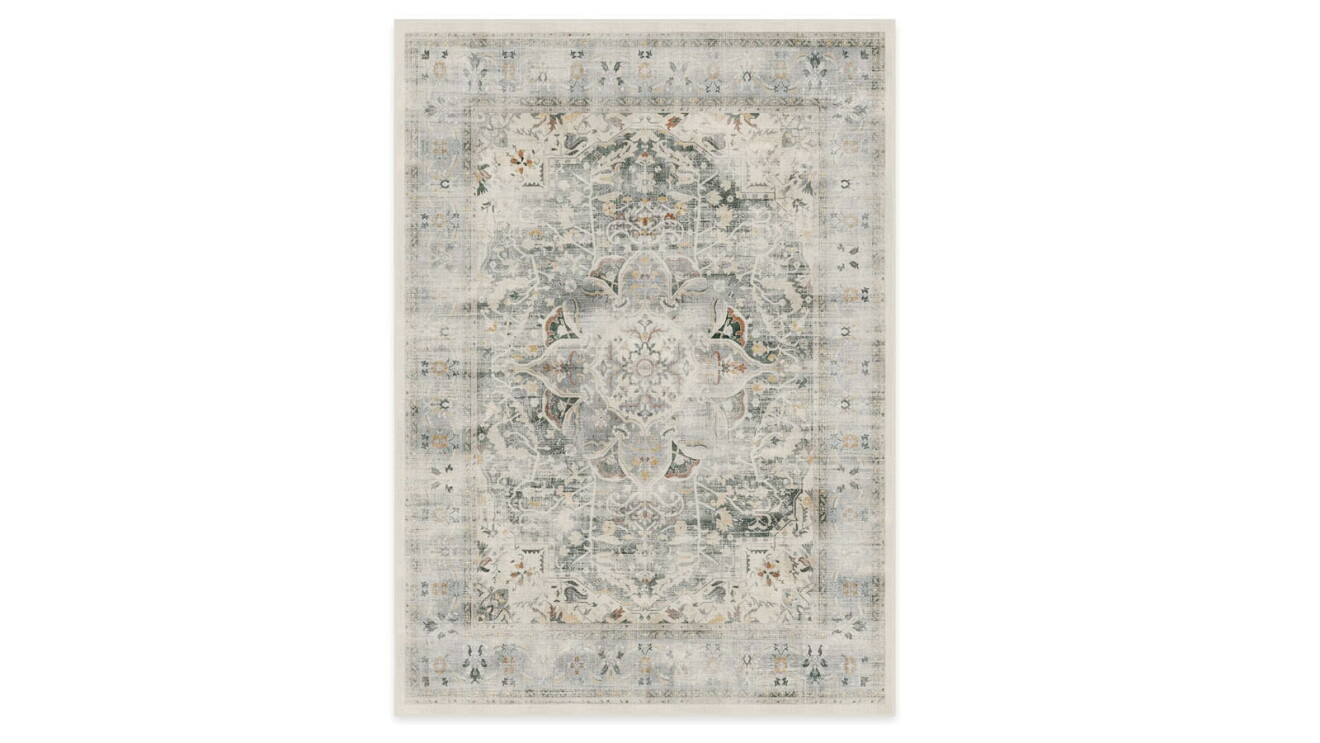 An image of a light gray area rug with a faded blue and tan design.