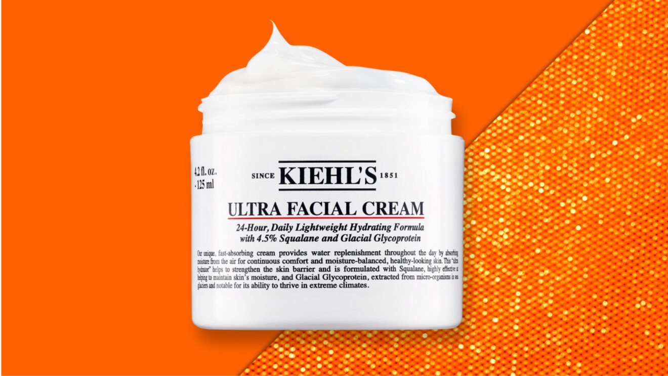 Kiehl's Ultra Facial Cream jar on vibrant orange background