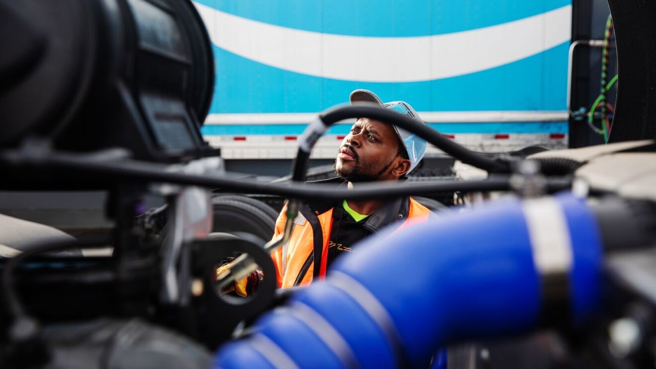 portraits and environmental photos of abel tuyisenge, a transportation operations management associate at amazon, as he drives and inspects trucks