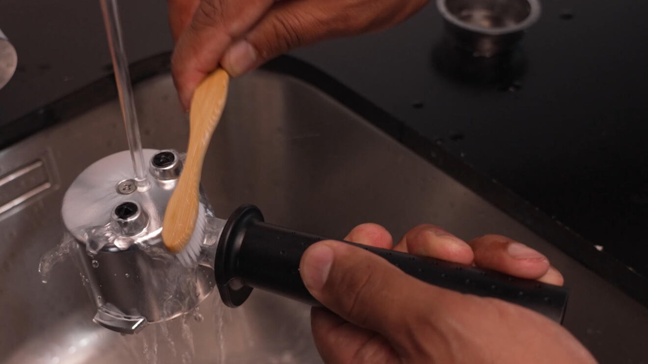 Using a toothbrush cleaning a offee filter
