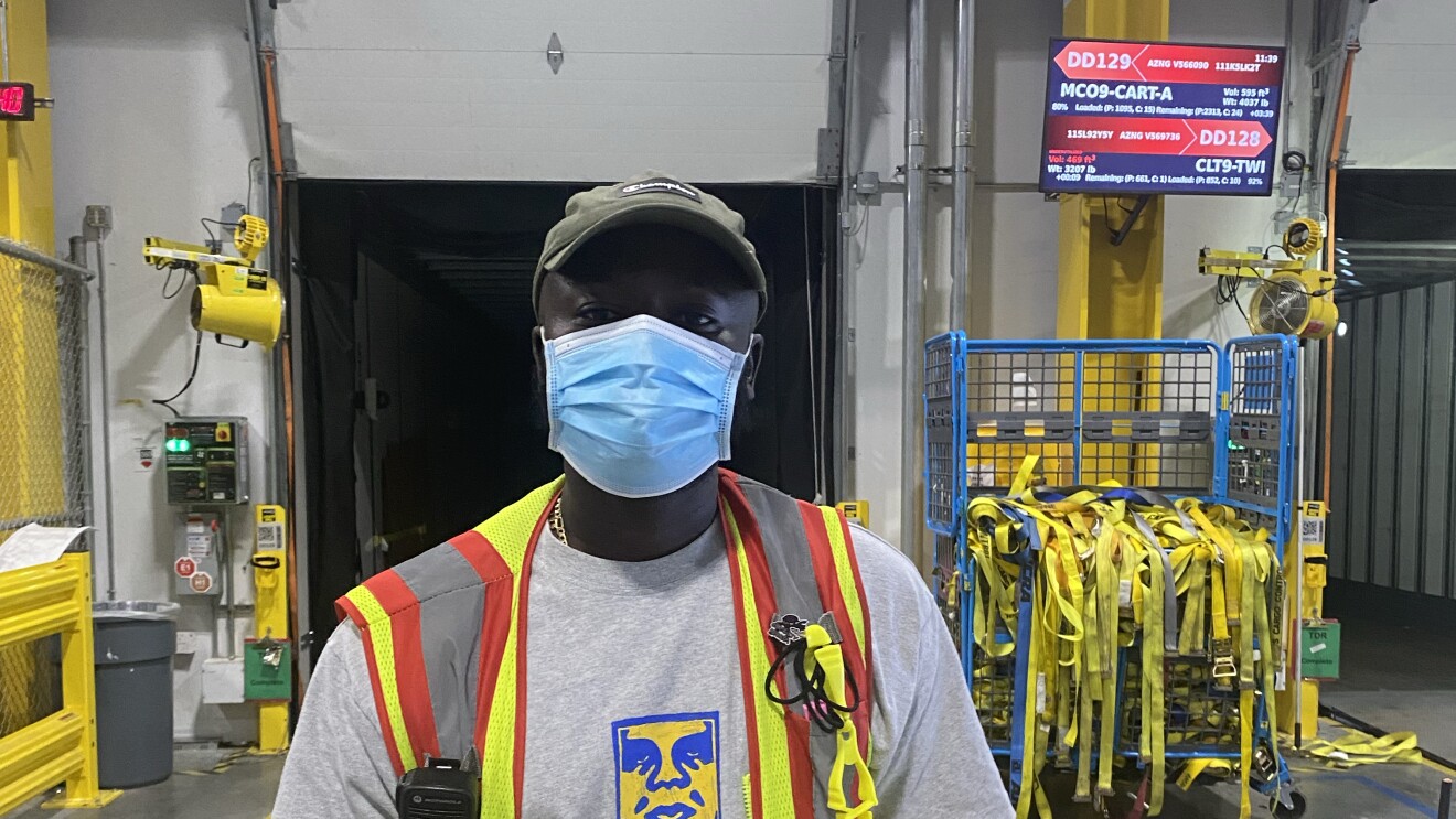 A single person in a safety vest at work with Amazon