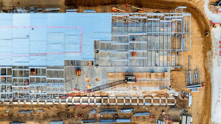 Aerial view of large-scale construction site for data center with steel framework