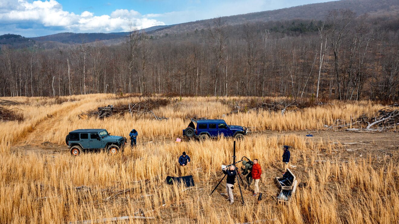 Images of people in a field using camera and test equipment.