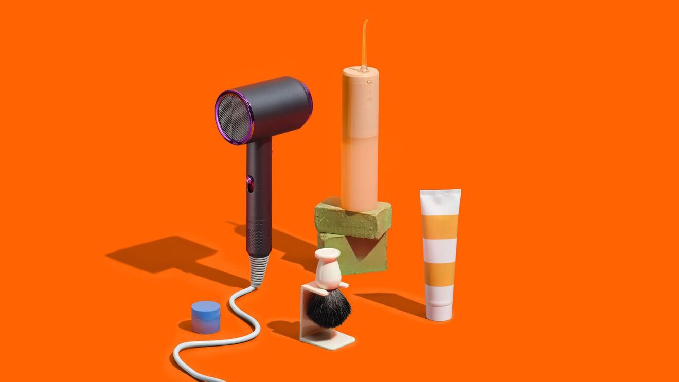 Personal care items arranged on vibrant orange background