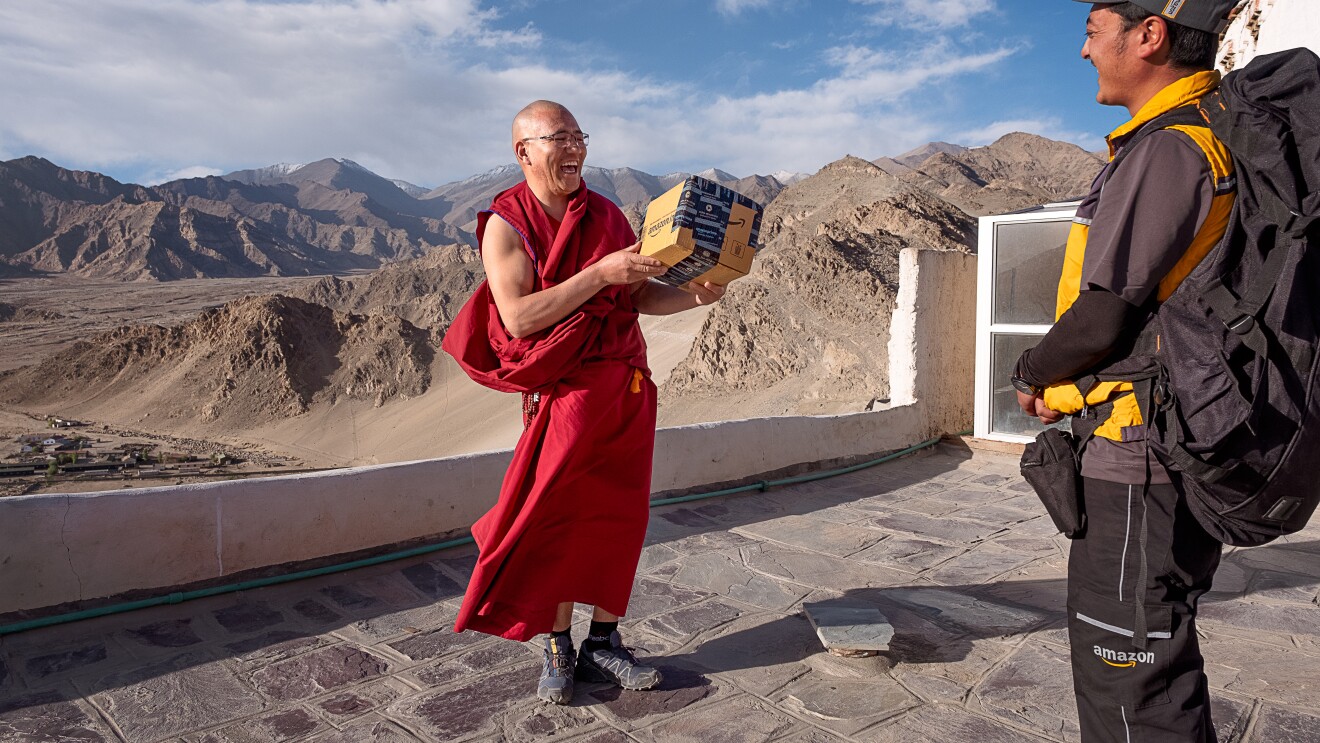 Happy customer in Leh receiving his parcel from an Amazon Delivery Associate