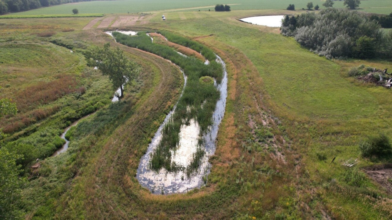 Kankakee Aquifer: Aerial view of curved waterway surrounded by fields and trees