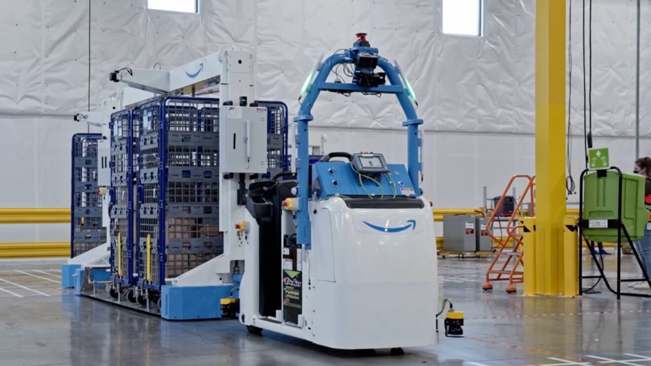 An image of a large robotic device pulling carts at an Amazon fulfillment center. 