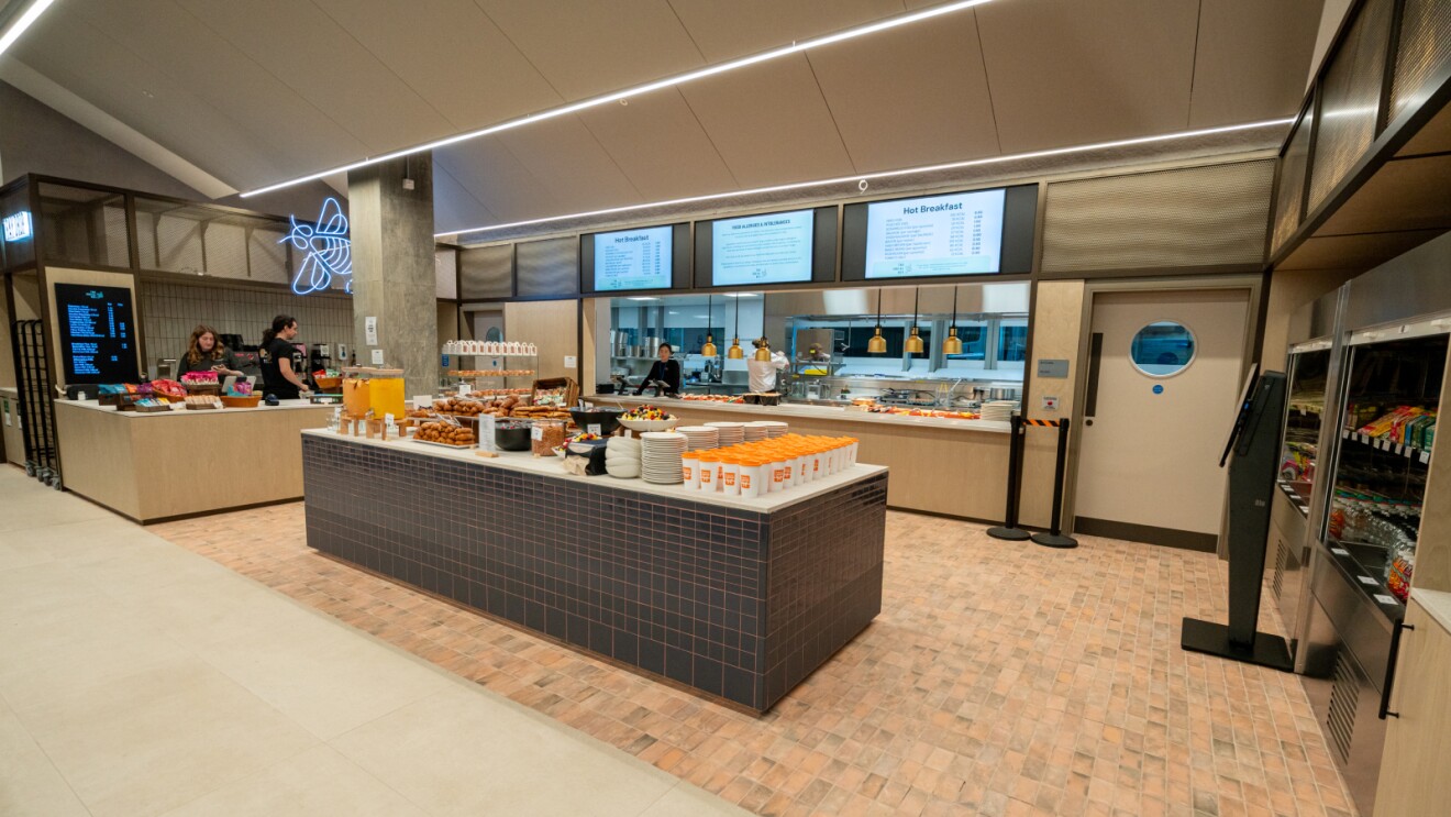 Modern cafeteria with self-serve buffet and digital menu boards