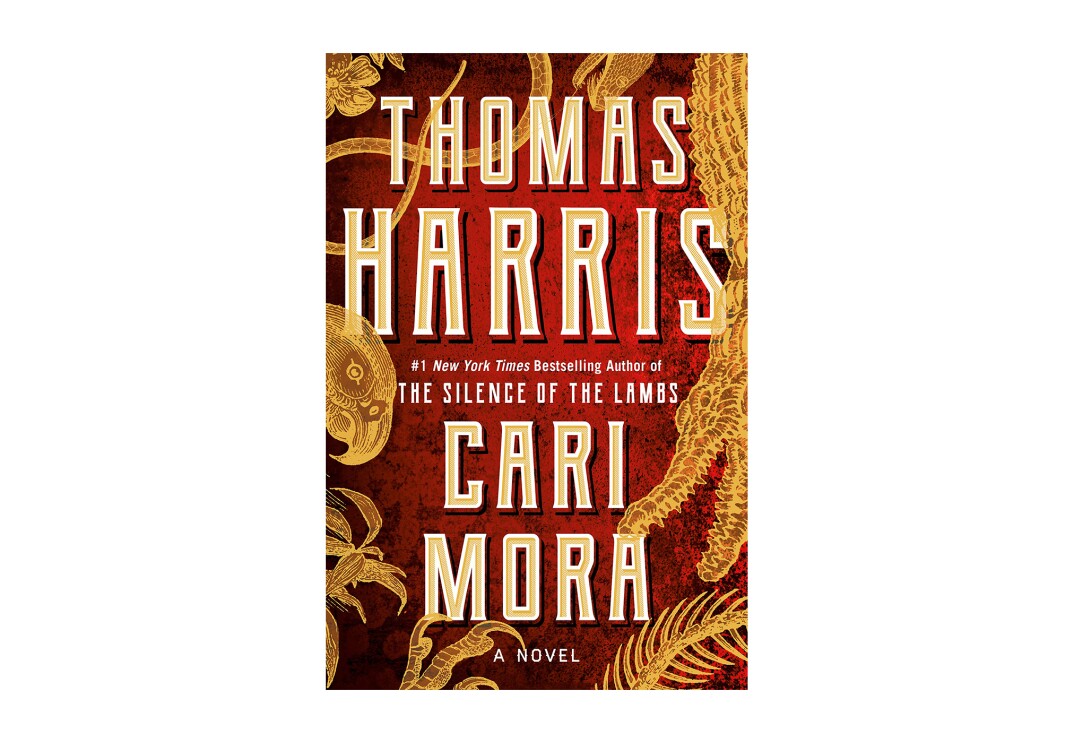 Book cover for the novel "Cari Mora" shows tall, ivory letters with the author's name, and the book title. The background is a deep red, with golden plant leaves swirling about.