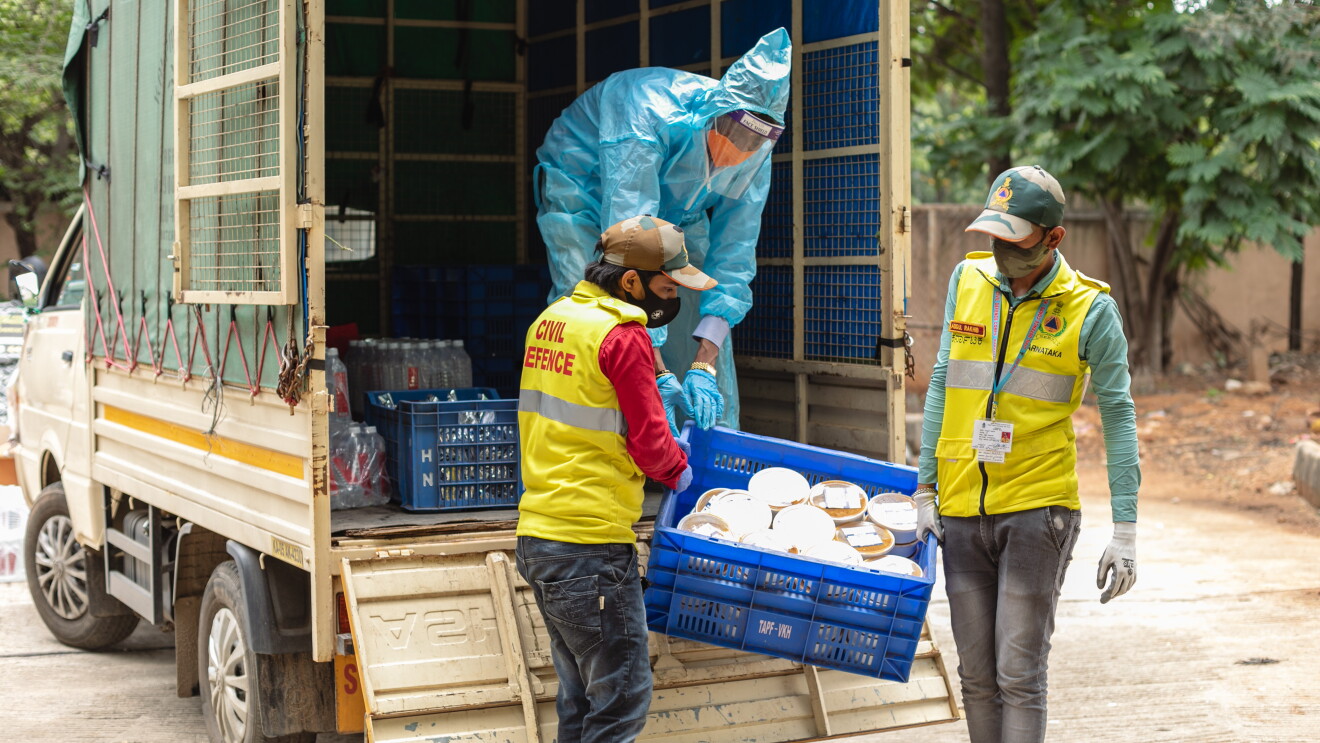 Workers unload essential rations for those in need as part of the Amazon and AkshayPatra meals program.