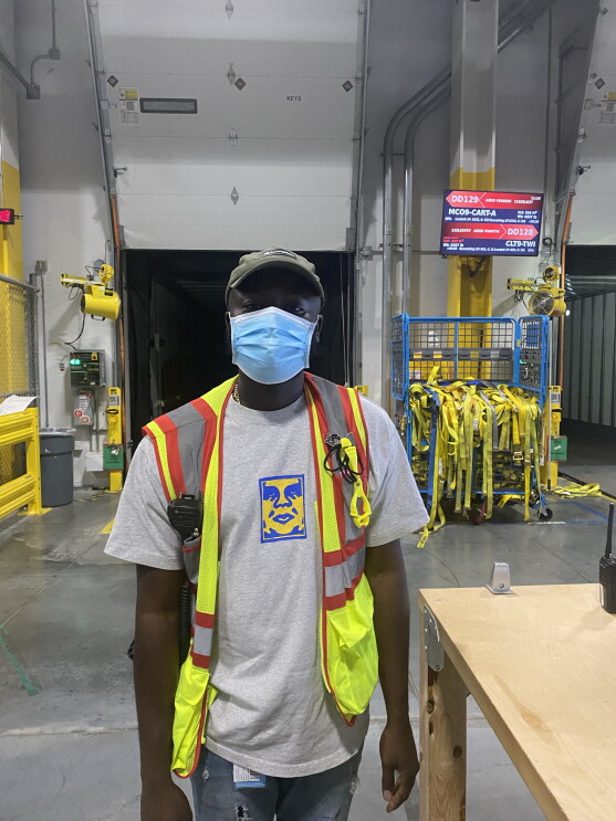 A single person in a safety vest at work with Amazon