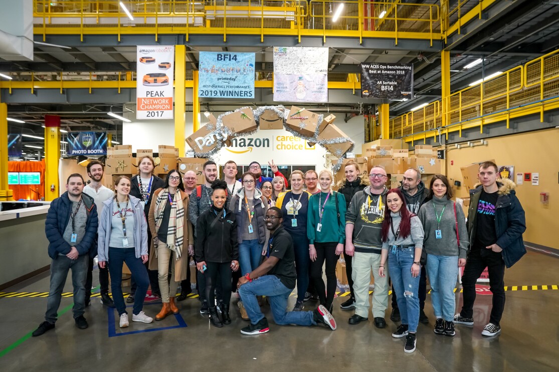 A group of Amazon employees on the 'I found the right place' programme standing in the Fulfilment Centre in Kent, Washington on a fulfilment centre tour.