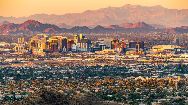 Aerial image of Phoenix with mountains in the background.