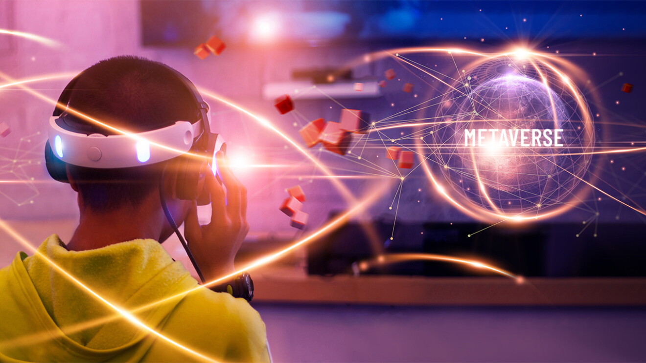 A teen gaming with a VR headset and a screen depciting metaverse