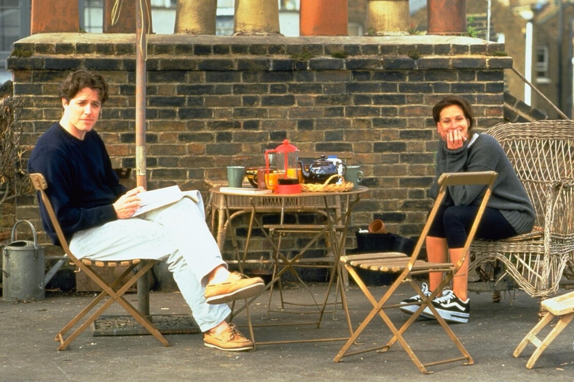 A man and a woman having tea outdoors