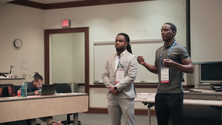 A photo of two team members presenting to an university classroom in the Rice Business Plan Competition (RBPC).