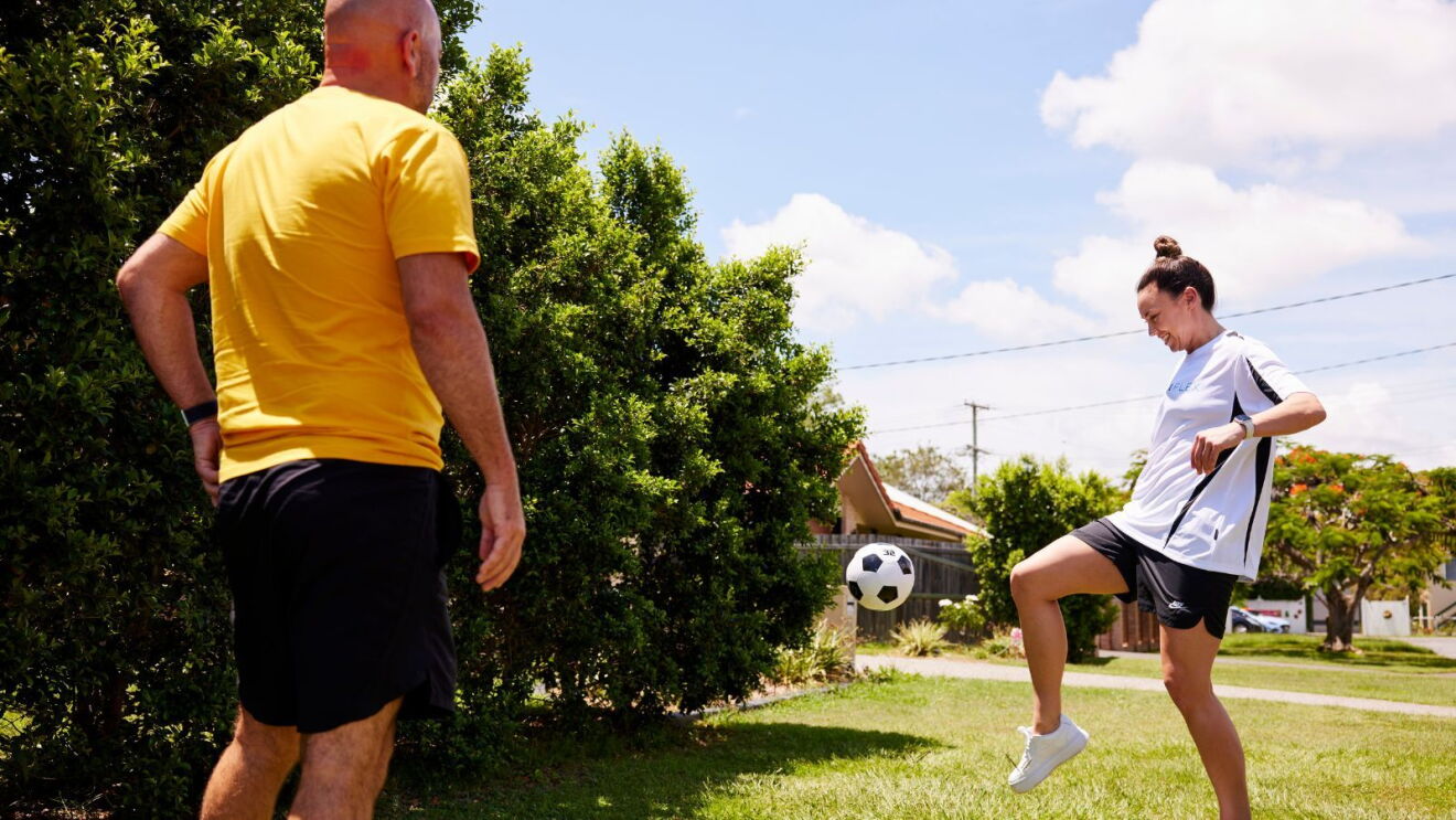 Mackenzie Arnold shows Amazon Flex driver Phil Rock some fancy football footwork.