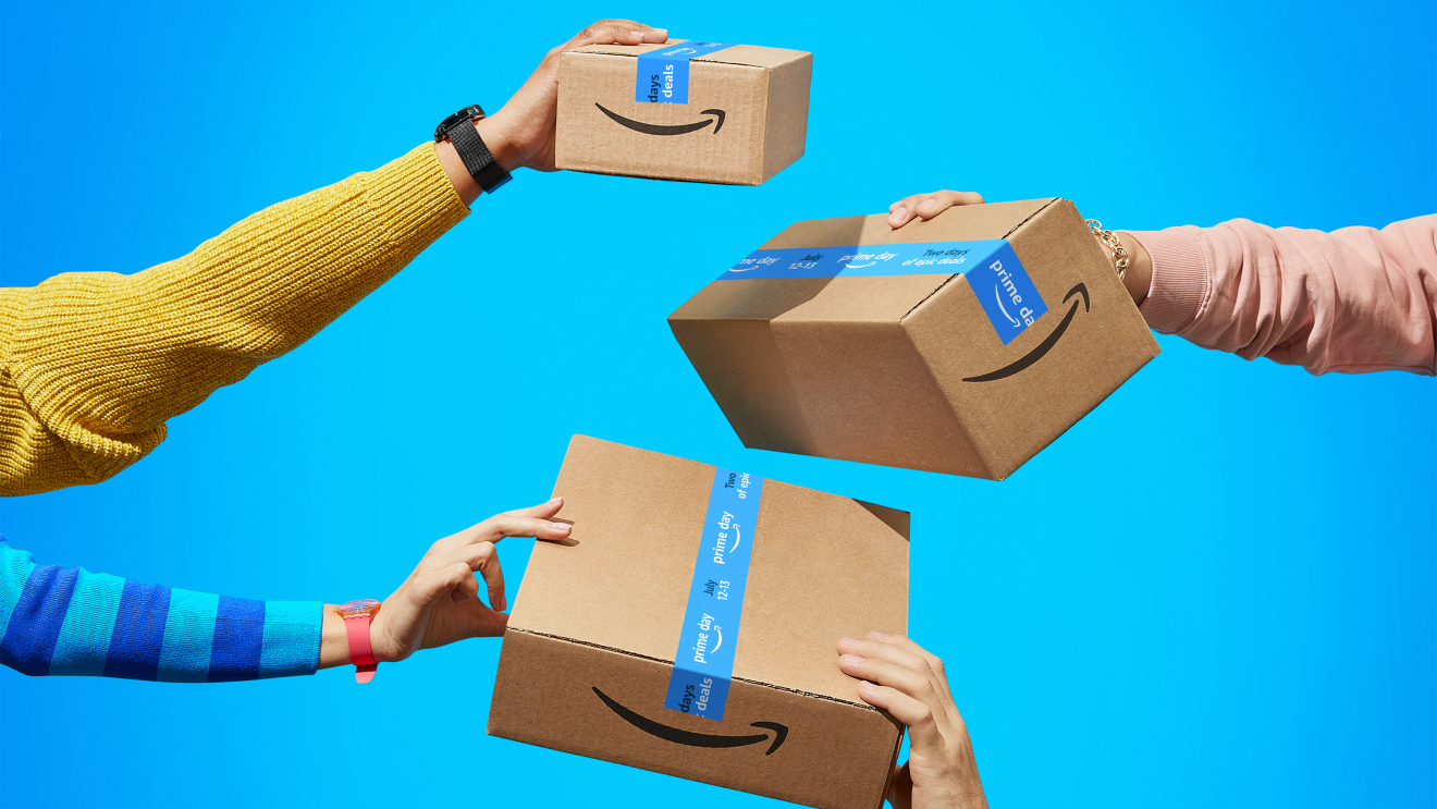 Multiple hands holding up Amazon boxes 
