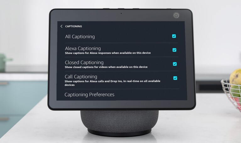 An image of an Echo Show with the screen showing Consolidated Captions that turns on Call Captioning, Closed Captioning, and Alexa Captions all at once.